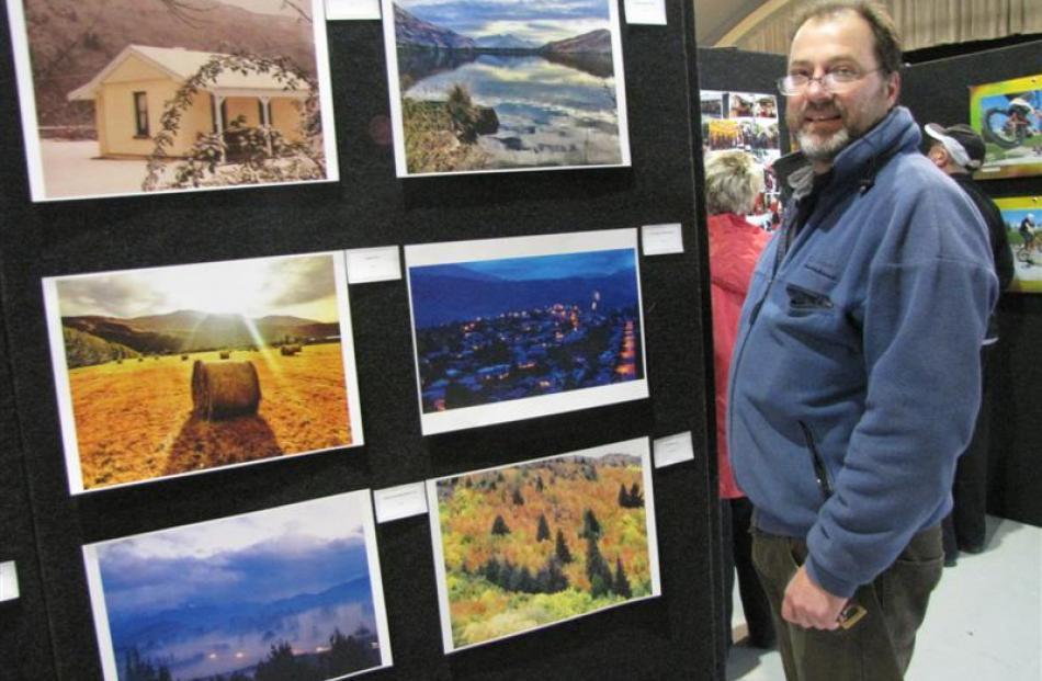 Arrowtown resident Rem Vis with some of his photographs, which form part of the Arrowtown Autumn...