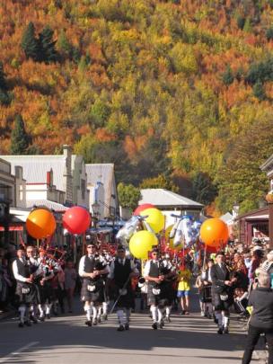 The Queenstown and Southern Lakes Pipe Band leads the 30th  Arrowtown Autumn Festival street...