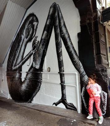 Ngarewa Bachop (3) checks out the Moray Pl mural completed by Phlegm last week.