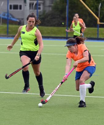 Caren van Gastel (right), of the One Hit Wonders, moves the ball away from Last Minute Decisions...