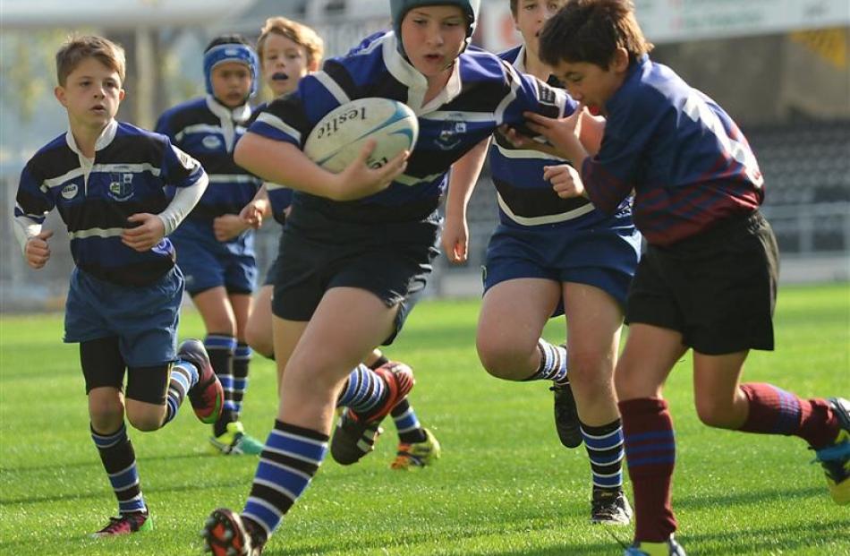 Kaikorai White under-11 player Michael Buttery on the burst against West Taieri.