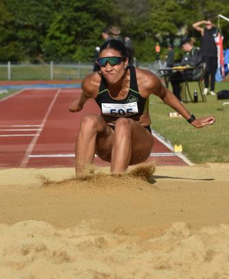 Aliyah Johnson of Auckland digs her heels in as she lands in the sand.