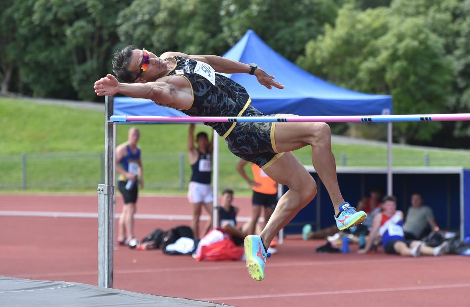 Keisuke Ushiro, of Japan, clears the bar in the high jump.