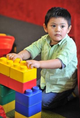 Gabby Fuentes (3) plays with blocks in the children's section.