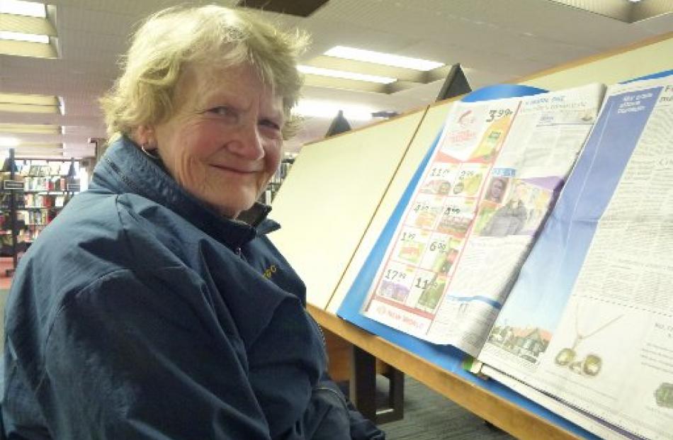 Jan Anderson reads the morning's Otago Daily Times.