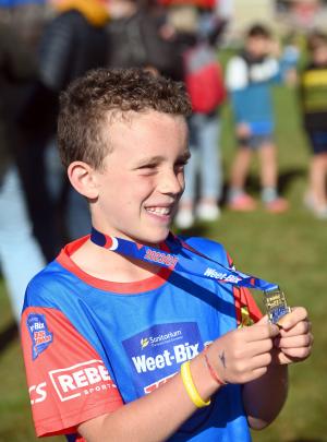 Max McKean, 9, of Dunedin, shows off his medal.