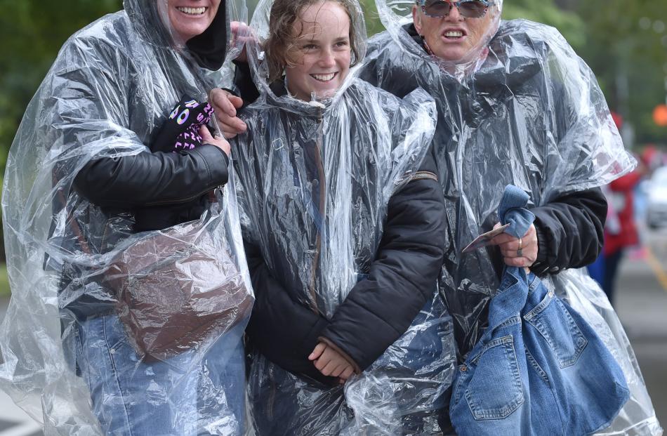 Braving the elements on the way to the stadium are (from left) Renee Growcott, of Hokitika, Eva...