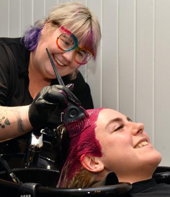 University of Otago master’s student Breana Riordan (23) has her hair dyed pink by Celeste Swale...