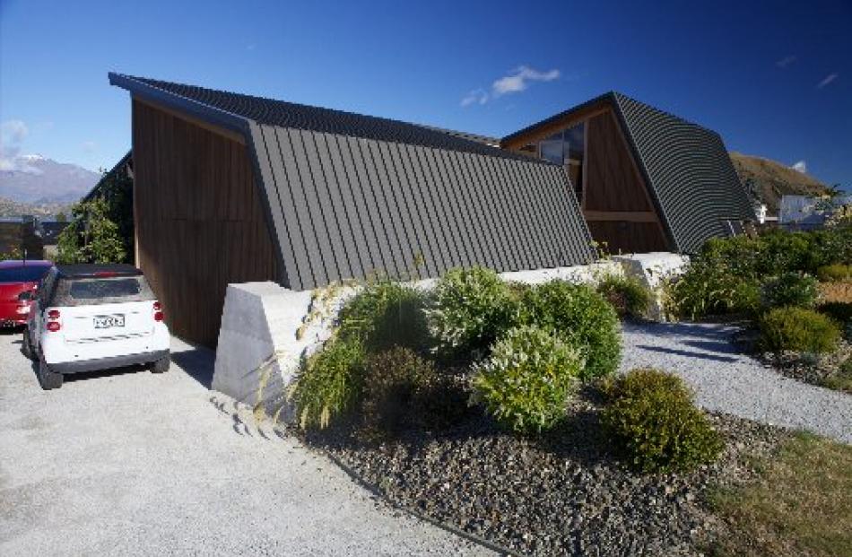 At the street, the roof becomes the walls and the walls, the roof.