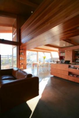 Plywood walls and a concrete floor feature downstairs.