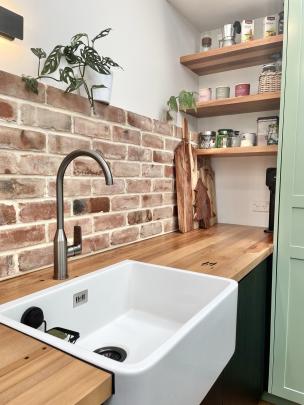 A large sink was a must. An unexpected benefit of the brick is the heat it radiates as it’s...