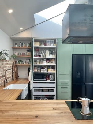 Kitchen designer Alison Chisman included a pantry with pocket doors that slide away into the...