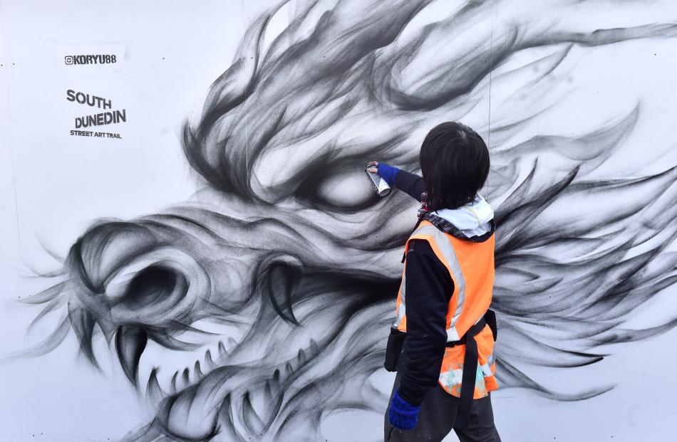 South Dunedin artist Koryu Aoshima creates a large mural of a dragon in King Edward St, as part...