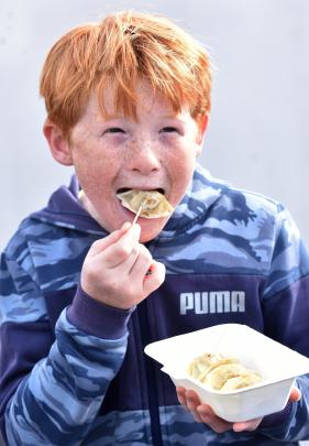 Benji McAuliffe, 11, of Dunedin, enjoys some of the local food on offer.