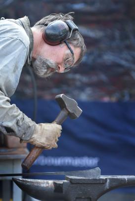 Dunedin blacksmith Kelly Gragg shows the public how he creates his steel art.