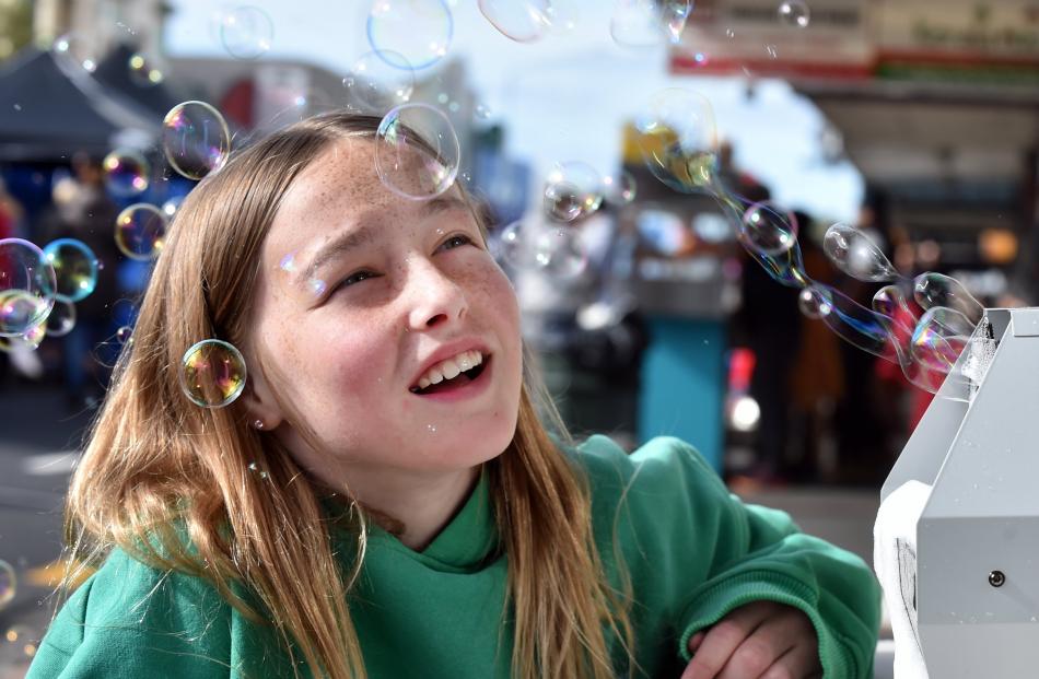 Macie Cameron, 11, of Dunedin, admires the source of hundreds of bubbles floating down King...