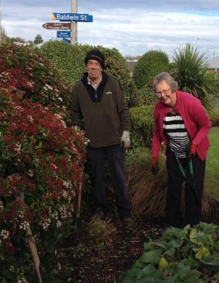 Heather Hore and her husband, Trevor, do some autumn tidying in the shrubbery.