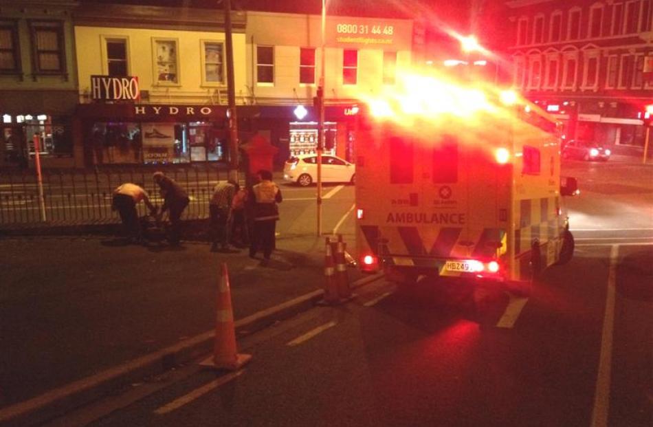 St John ambulance officers attend to a student who passed out in the grounds of Knox Church....