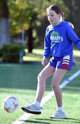 Billie Meddings, 10, of St Mary’s School, tries out some football skills. PHOTOS: PETER MCINTOSH