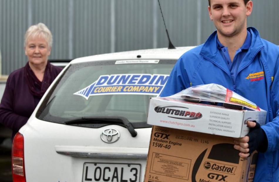 Dunedin Courier Company office manager Di Cochrane with courier Sam Stevenson (23).