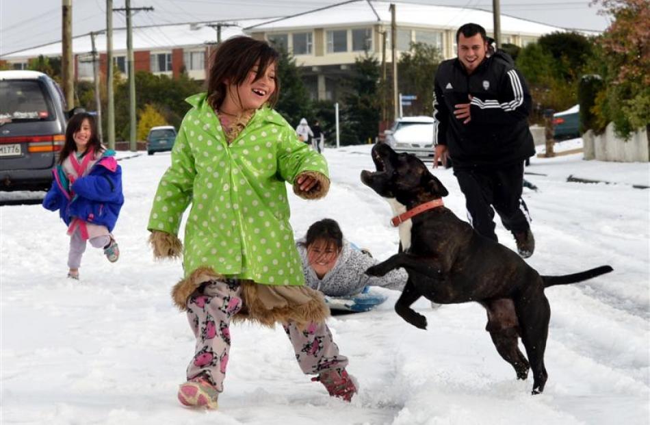 Coming down Wray St in Brockville yesterday are (from left) Tiana Tairi (4), Wairua Tairi-Hema...