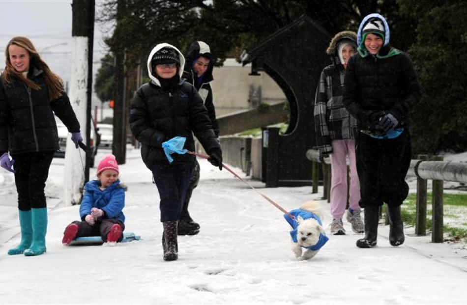 Walking along Victoria Rd yesterday are (from left) Anika Ayson (16), Sari Ayson (5), Shani Ayson...