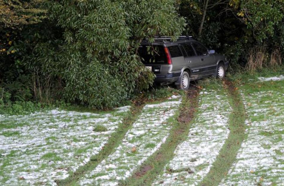 A car that slid off Eglinton Rd, Mornington, yesterday. Photos by Craig Baxter.