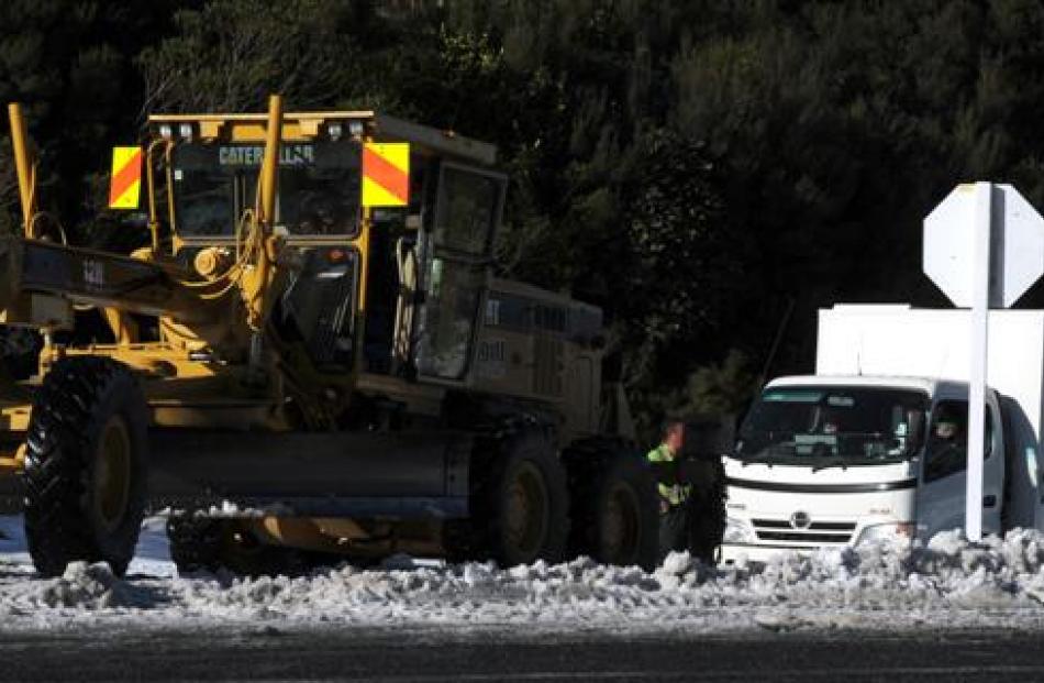 A snow grader tows an Otago Corrections Facility van in Leith Valley Rd yesterday.