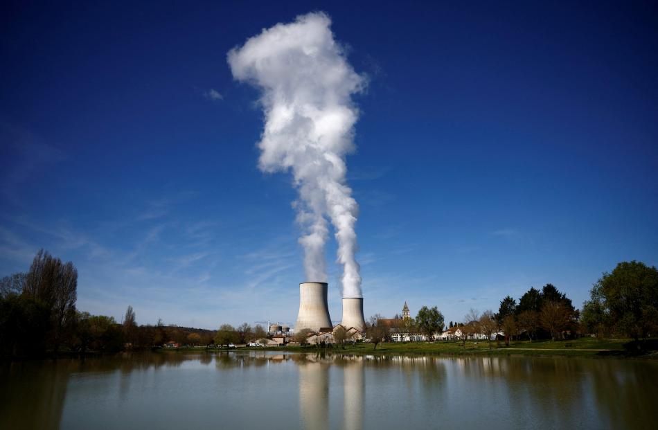 Steam rises from cooling towers of the Electricite de France nuclear power station in Civaux,...