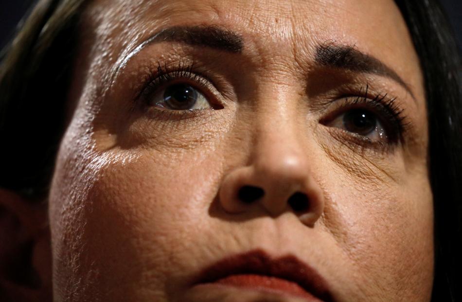 Venezuelan opposition leader Maria Corina Machado looks on while addressing the media, in Caracas...