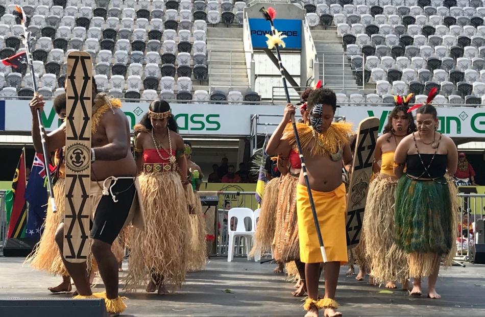 A Moana Nui performance from a Papua New Guinea group is led by two warriors in traditional costume.