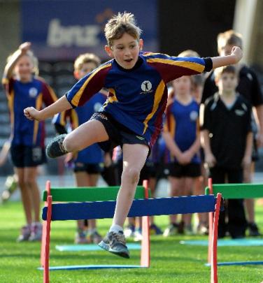 Ben Nicol (10), of Outram School, jumps over a hurdle.