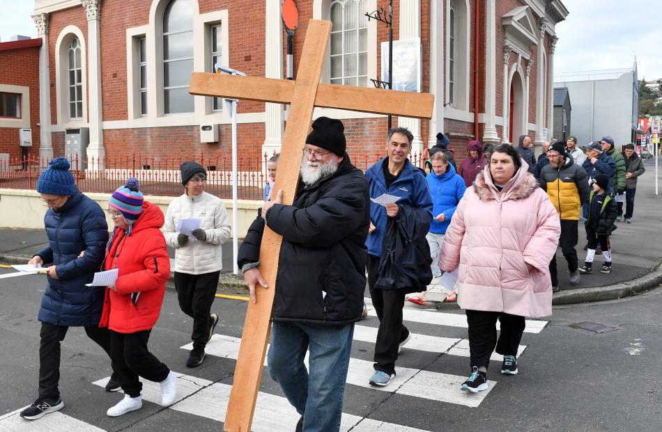 Barry Tipler carries the cross as fellow members of the Caversham Baptist Church head off on a...