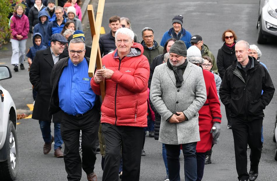 Greg Hughson leads parishioners up Whitby St, from St Mary’s Church in Mornington yesterday....