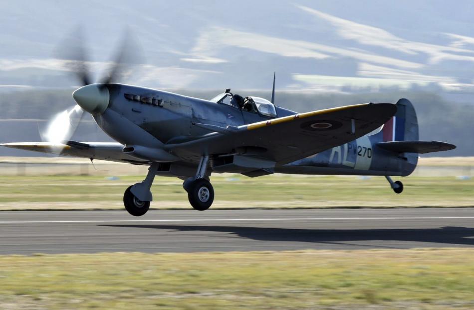 A Spitfire flown by Stu Anderson takes off for a practice flight.