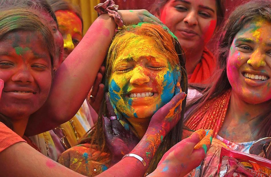 People play with coloured powder during Holi celebrations in Nagaon district, Assam, India. PHOTO...