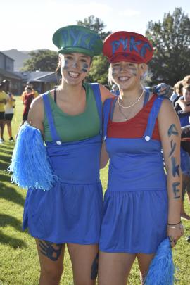 Mayce Williams (left) and Peta Smith support their team at the Dunstan High School athletics...