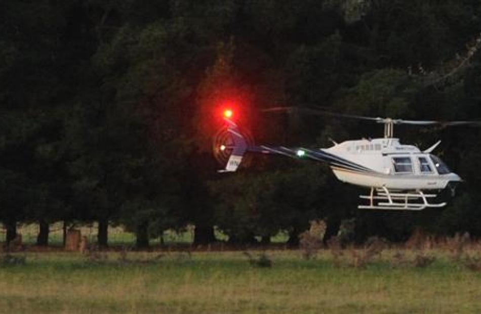 A helicopter is used to search for  escaped prisoner Stephen Uriah Maddren on a Milburn farm ...