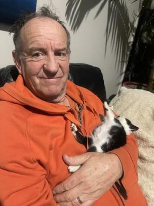 Rob Fisher with a rescued stray kitten. Photo: Supplied