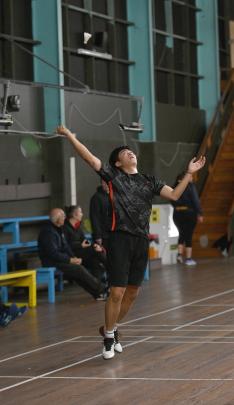 Alex Zhao, of Christchurch, reaches high during the men’s singles semifinals.