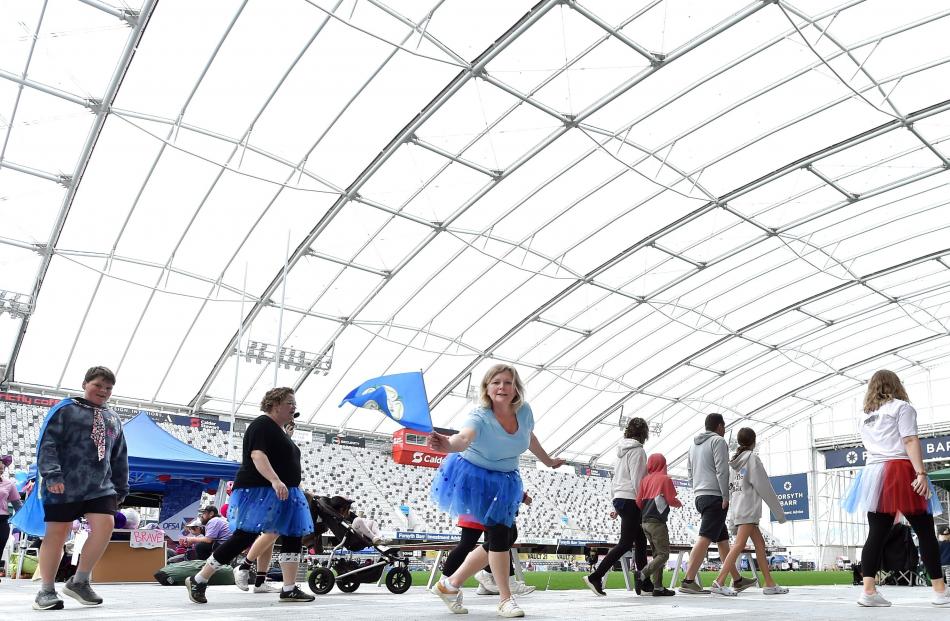 Participants in the Dunedin Relay for Life fundraiser complete laps at Forsyth Barr Stadium on...