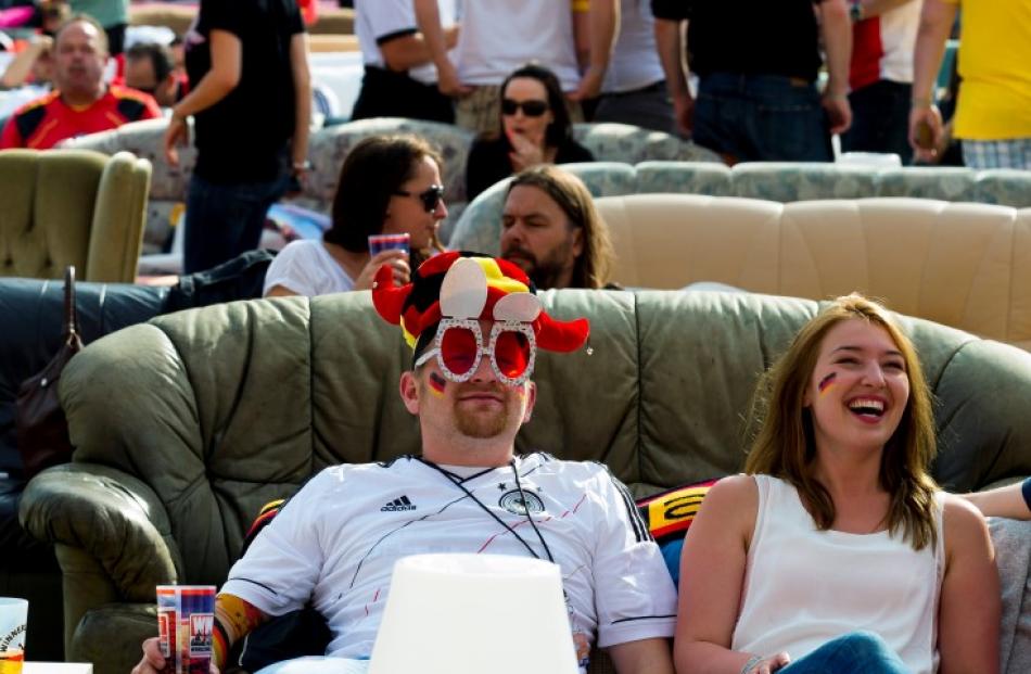 A couple of fans enjoy watching Germany take on Portugal. REUTERS/Thomas Peter