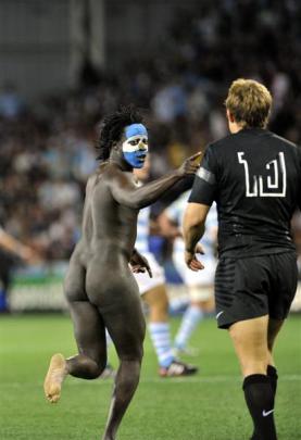 A streaker gestures to English first five Johnny Wilkinson during England and Argentina's Rugby...
