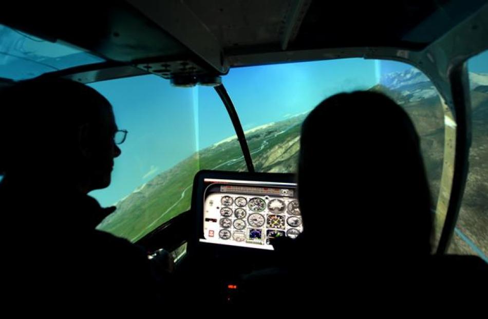 Graeme Gale takes Jade for a trial in a simulator before her real-life flight.