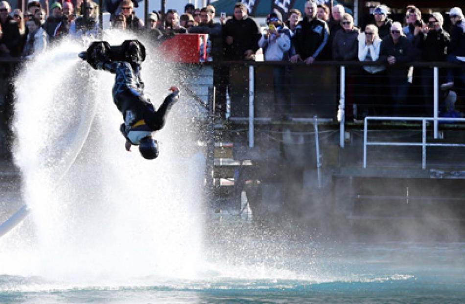 A flyboard rider performs for the crowd.