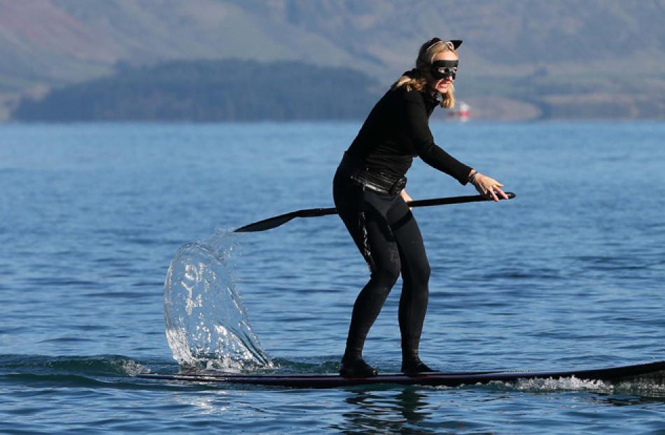 Ange West competes in the paddle board race.