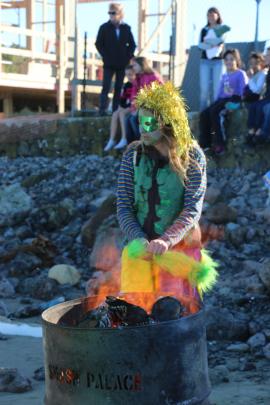 Lou Petch, of Oamaru, keeps warm before entering the water.