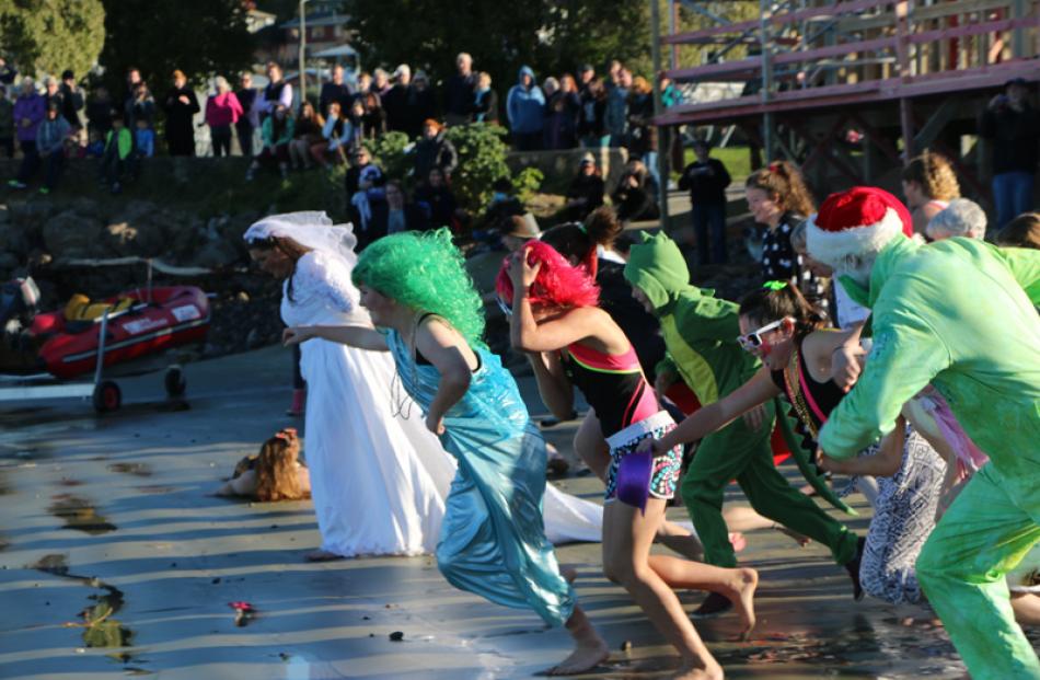 Swimmers race to the water.