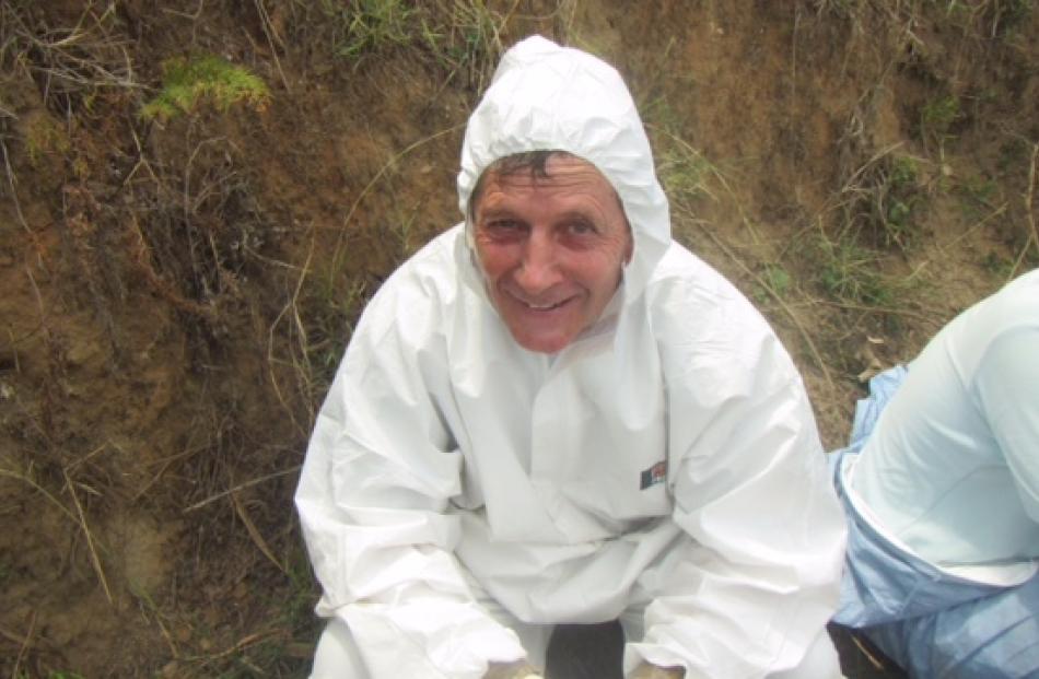 Oamaru vet Ivan Holloway said it was exhausting wearing plastic anti-contamination suits in...