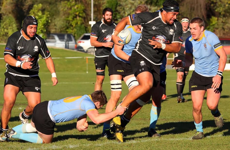 Univertsity A first-five Stephen Fenemor keeps hold of Pirates prop Hisa Sasagi while other...